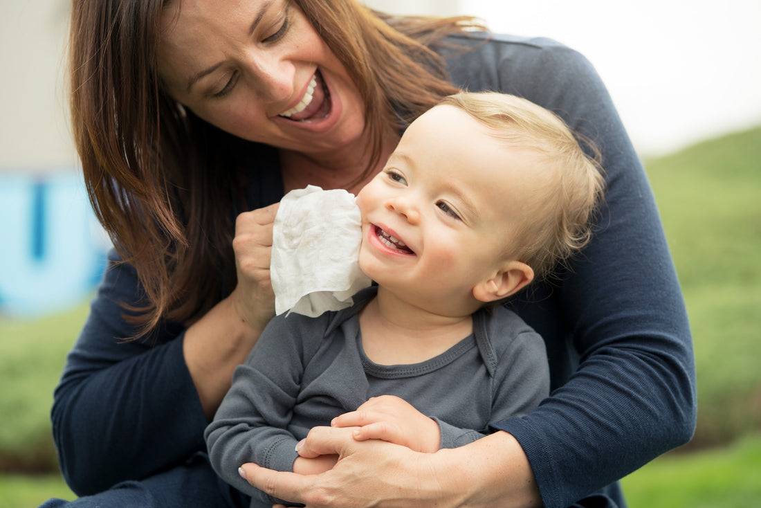 Mom wiping baby cheek