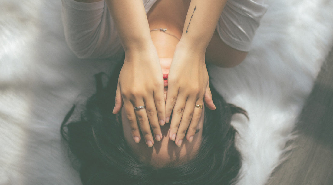 Woman covering face with her hands