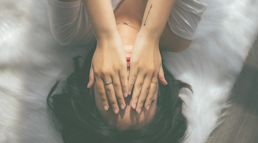 Woman covering face with her hands