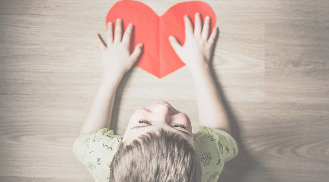 Boy with paper heart cutout