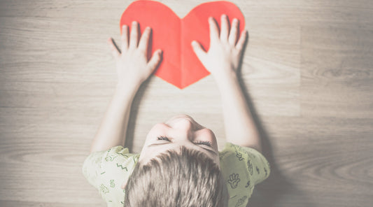 Boy with paper heart cutout