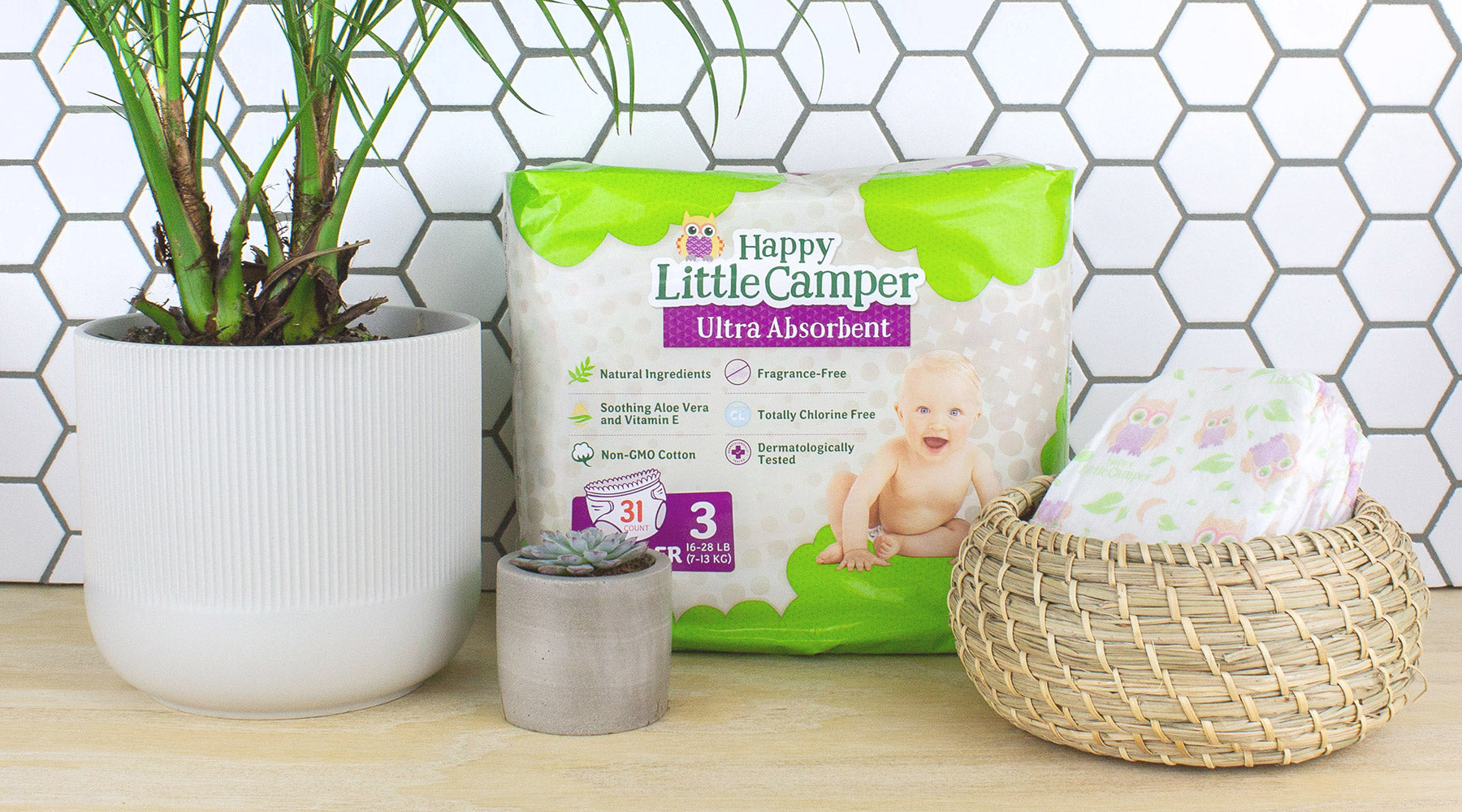 Package of diapers on counter with plants