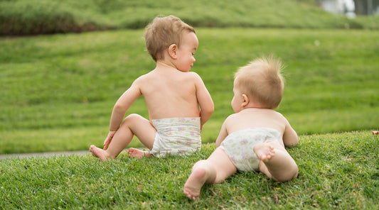 Babies in diapers on grass